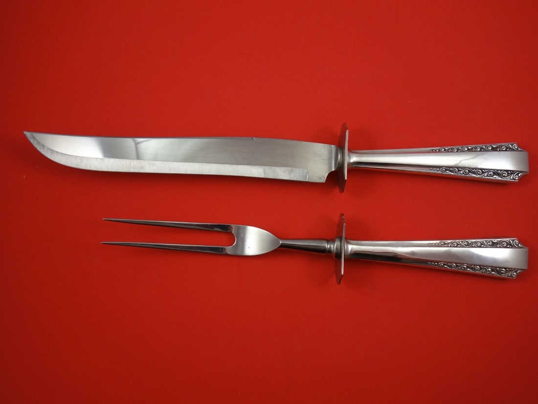 Watson American Colonial Sterling Silver 2-Piece Carving Set: Watson American Colonial Sterling Silver 2-Piece Carving Set Enhance your dining experience with this exquisite 2-piece roast carving set from the American Colonial pattern by Watson. Crafted from hig