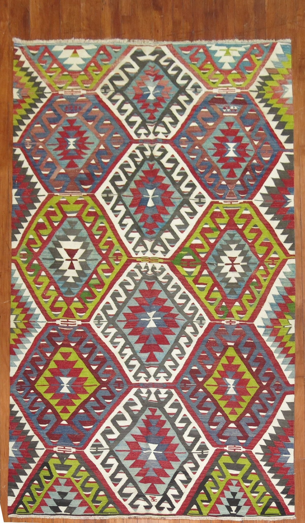 5' 2" x 9' 10" Turkish Kilim Rug Geometric Mid 20th Century: 5' 2" x 9' 10" Turkish Kilim Rug Geometric Mid 20th Century Vintage Turkish kilim with a colorful geometric design from the mid-20th century. This pre-owned rug features a bold pattern consistent with