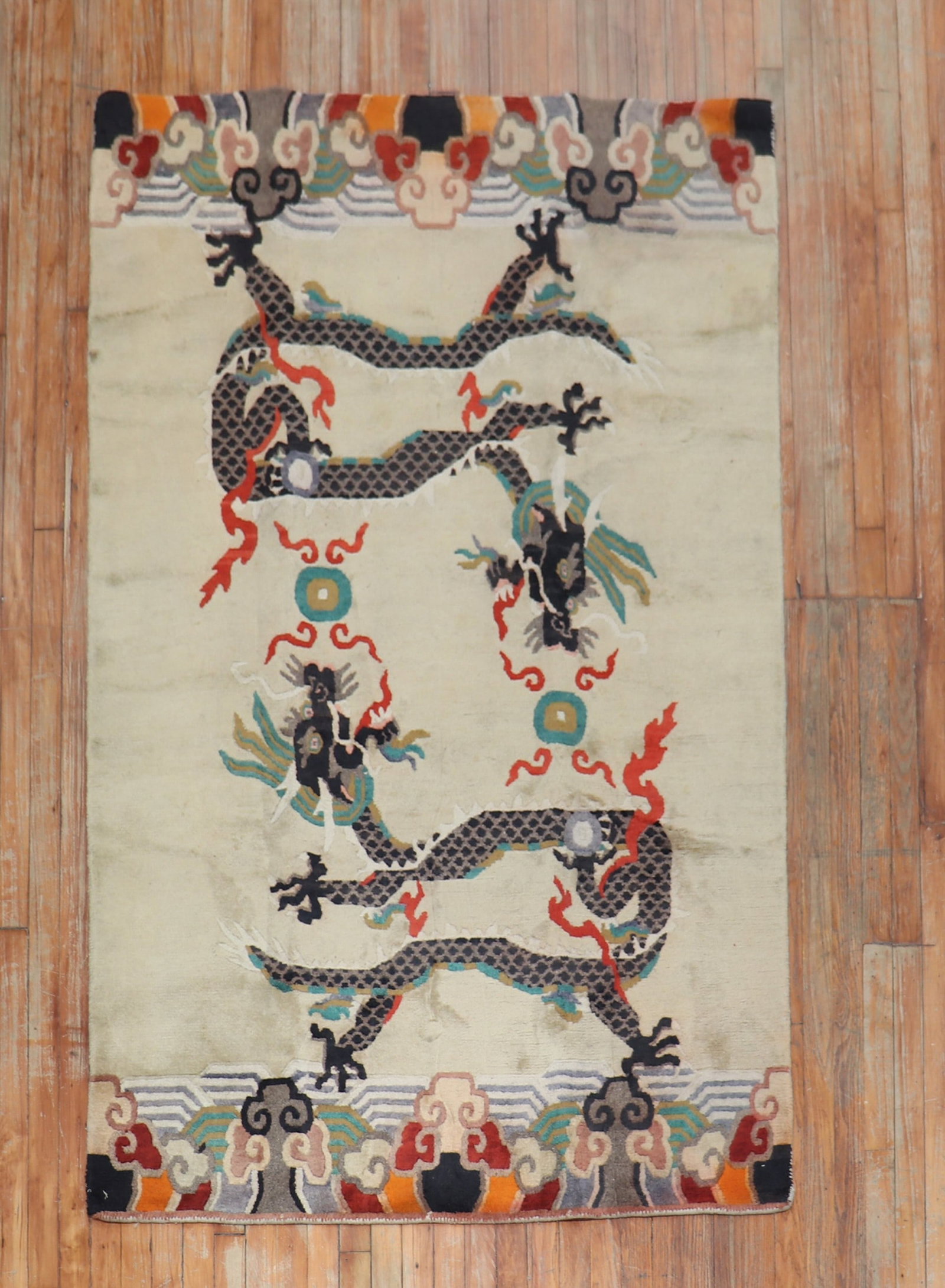4' 4" x 6' 10" Pictorial Tibetan Accent Rug Dragon Motif: 4' 4" x 6' 10" Pictorial Tibetan Accent Rug Dragon Motif Vintage Tibetan pictorial accent rug featuring a dragon motif on a beige field. This pre-owned piece dates to the third quarter of the 20th cen