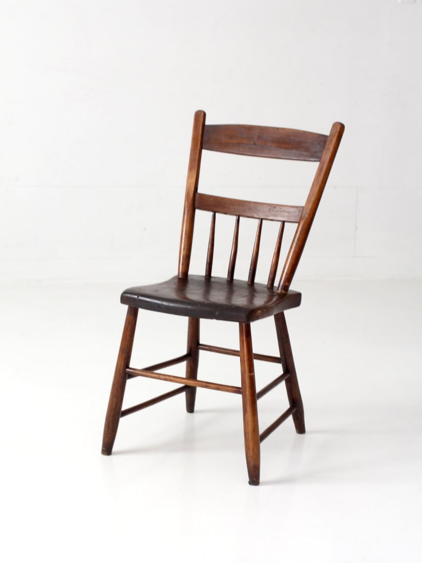 Primitive Spindle Back Side Chair with Plank Seat Antique: Primitive Spindle Back Side Chair with Plank Seat Antique Antique primitive side chair with a plank seat and spindle back. Its simple form is accented by gently curved rails, slender turned legs, and 