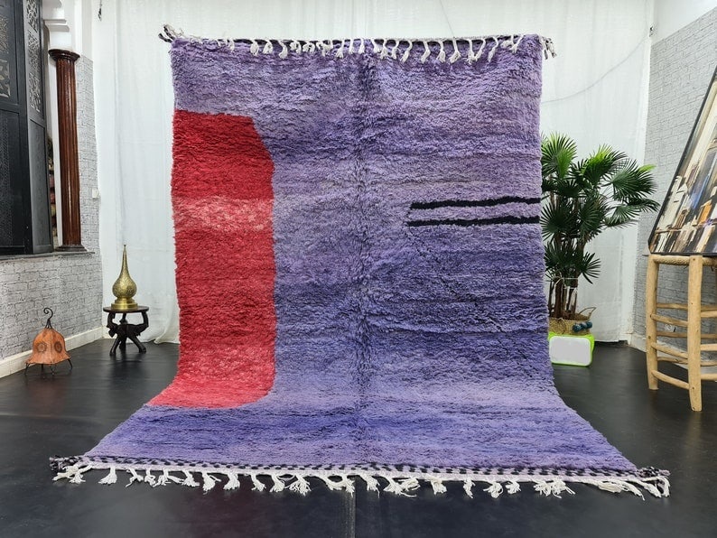 Authentic Handwoven Moroccan Berber Rug in Purple with Red Accents: Authentic Handwoven Moroccan Berber Rug in Purple with Red Accents Experience the beauty of authentic craftsmanship with this stunning handwoven Moroccan Berber rug. Featuring a soft purple base accen