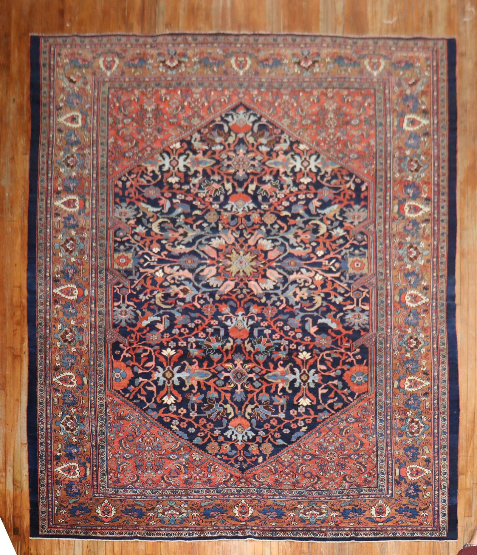 10' 6" x 13' 3" Persian Sultanabad Mahal Room Rug: 10' 6" x 13' 3" Persian Sultanabad Mahal Room Rug Early 20th century Persian Mahal rug featuring a traditional navy field with rust, light blue, and coral accents. This pre-owned room-size rug is iden