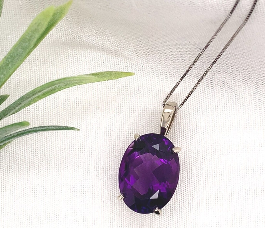 14k White Gold 12.52 Carat Oval Amethyst Pendant with GIA Certification: 14k White Gold 12.52 Carat Oval Amethyst Pendant with GIA Certification Elevate your jewelry collection with this stunning 14k white gold pendant featuring a magnificent 12.52-carat oval cut genuine n