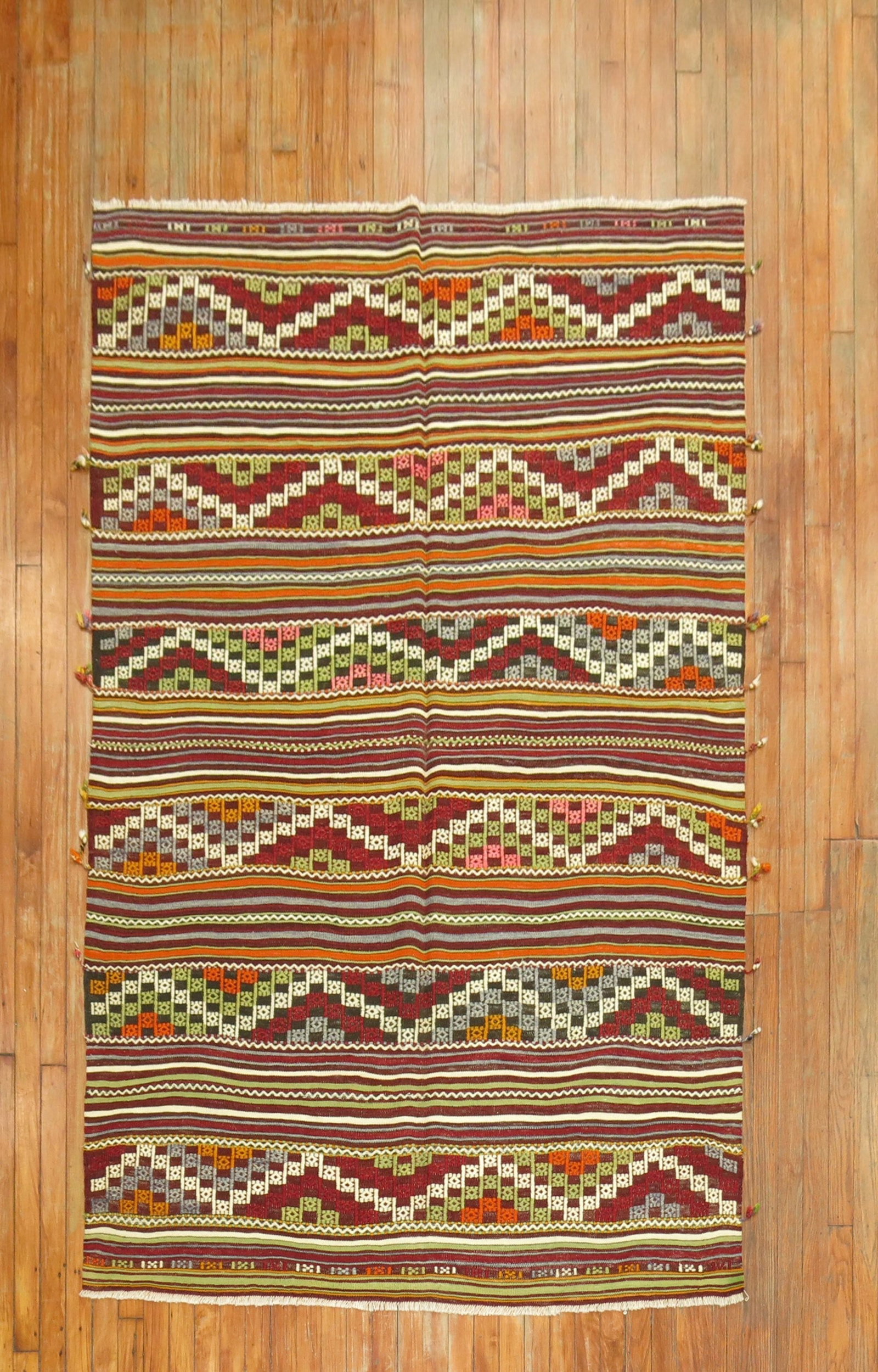 4' 11" x 7' 4" Turkish Jajim kilim accent rug: 4' 11" x 7' 4" Turkish Jajim kilim accent rug One-of-a-kind vintage Turkish Jajim flatweave from the 20th century, featuring colorful geometric motifs and striped patterning. This pre-owned accent rug