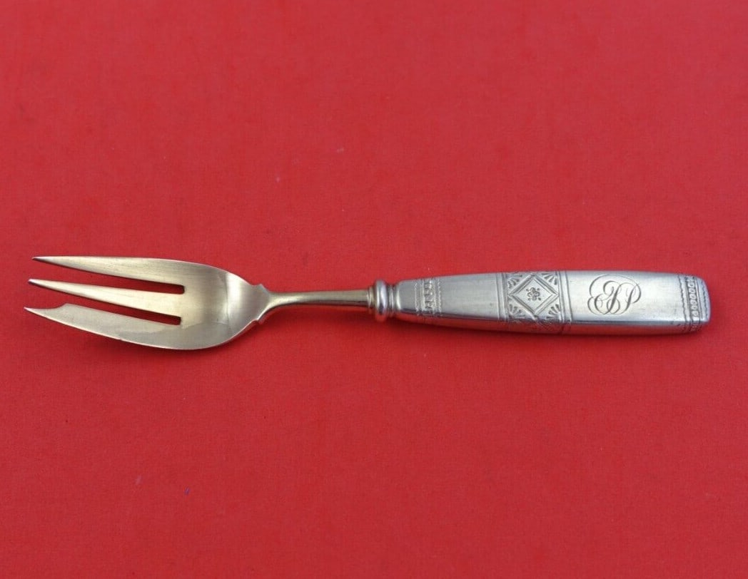 Tiffany & Co Sterling Silver Gold Washed Oyster Fork 5 3/8": Tiffany & Co Sterling Silver Gold Washed Oyster Fork 5 3/8" This exquisite oyster fork from Tiffany & Co. is crafted from sterling silver (.925) and features a gold washed, bright-cut finish. Measurin