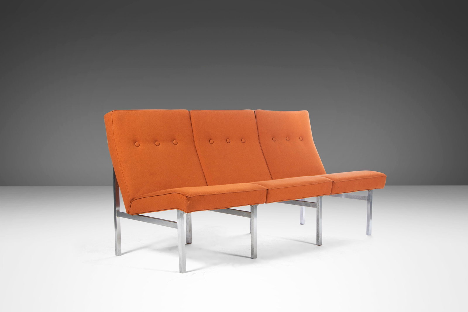 Mid-Century Modern Three Seat Sofa in Orange Upholstery on Chrome Base: Mid-Century Modern Three Seat Sofa in Orange Upholstery on Chrome Base This striking Three Seat Sofa / Bench features original orange upholstery beautifully set on a sleek chrome base, inspired by the