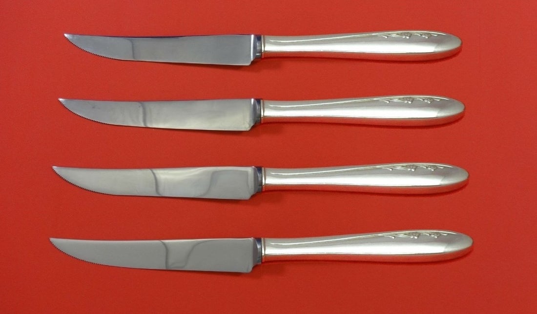 Lunt Spring Serenade Sterling Silver Steak Knife Set 4pc Custom 8.5": Lunt Spring Serenade Sterling Silver Steak Knife Set 4pc Custom 8.5" Enhance your dining experience with this exquisite 4-piece steak knife set from the Spring Serenade pattern by Lunt. Crafted from h