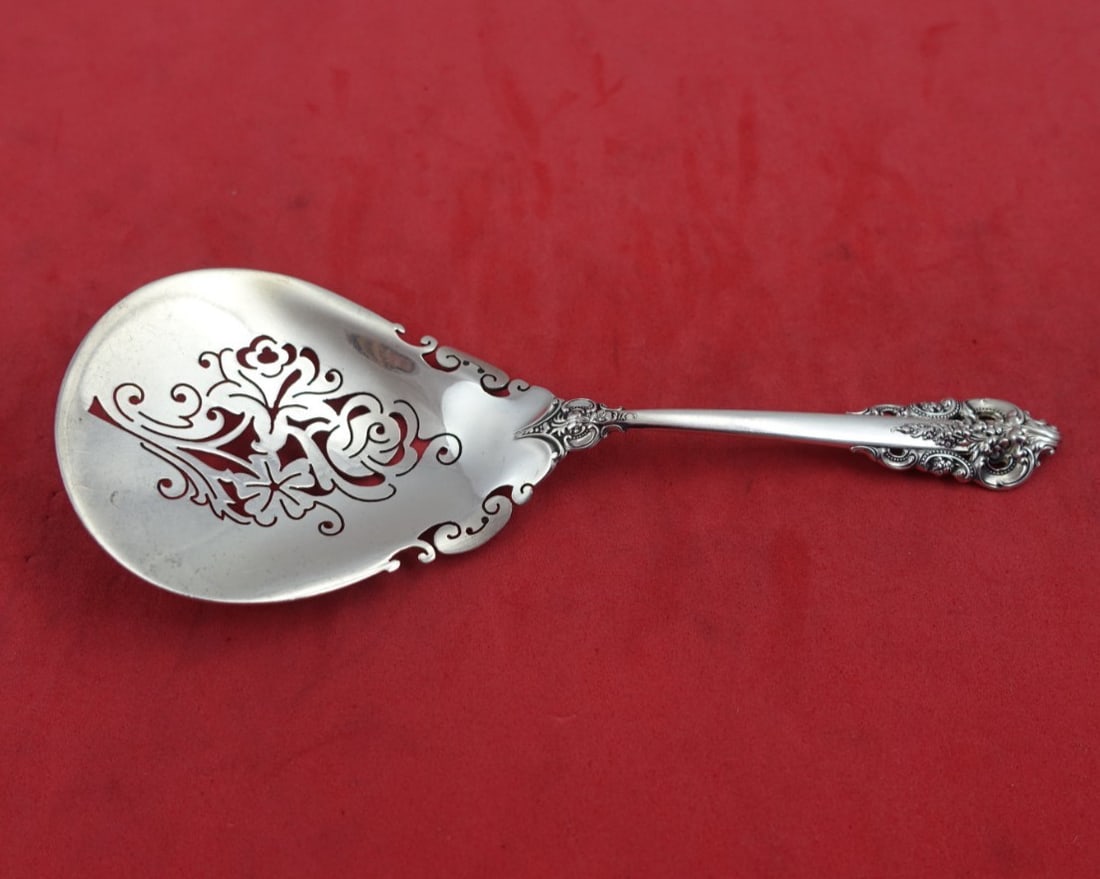 Wallace Grande Baroque sterling nut spoon pierced roses 5 1/4 in: Wallace Grande Baroque sterling nut spoon pierced roses 5 1/4 in This is a sterling silver nut spoon in the Grande Baroque pattern by Wallace. Featuring an ornate pierced design with roses and flowers