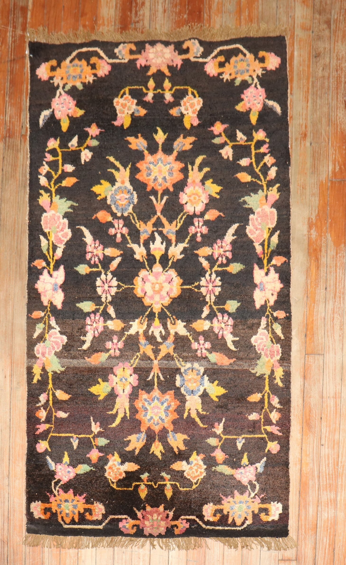 2' 9" x 4' 10" Mid 20th Century Tibetan Floral Rug: 2' 9" x 4' 10" Mid 20th Century Tibetan Floral Rug Vintage floral Tibetan rug featuring a multicolor floral design on a brown ground. This mid 20th century small rug is pre-owned. Specifications Item 