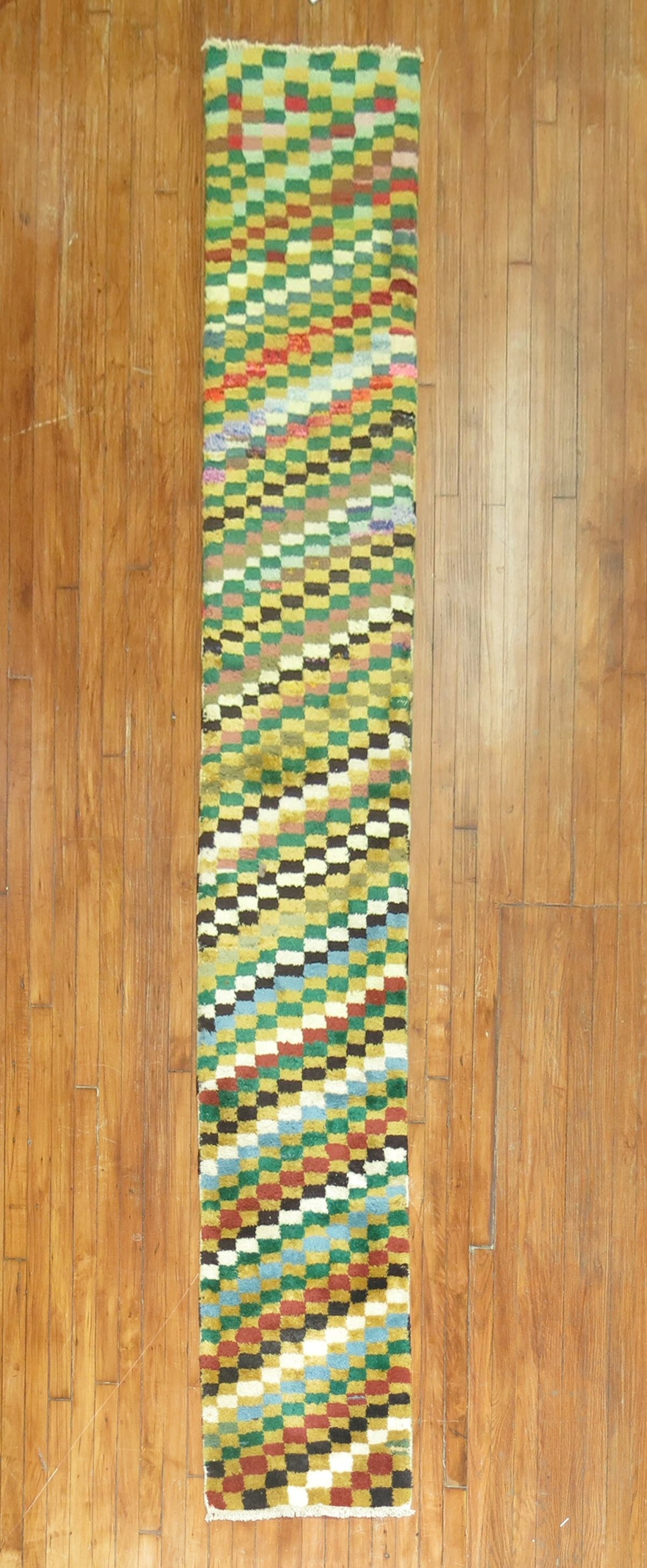 1' 8" x 10' 7" Turkish Deco runner with checkerboard design: 1' 8" x 10' 7" Turkish Deco runner with checkerboard design Narrow Turkish Deco runner featuring a colorful checkerboard design. Pre-owned. Specifications Type: Turkish Deco Category: Runner Dimension