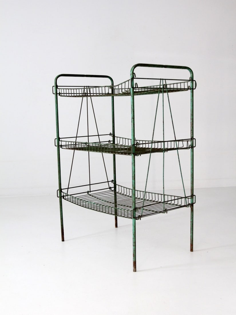 Vintage Industrial Green Metal Wire Shelf with Patina: Vintage Industrial Green Metal Wire Shelf with Patina Enhance your home or office with this vintage industrial metal wire shelf, combining style and functionality. This rack features a charming green 