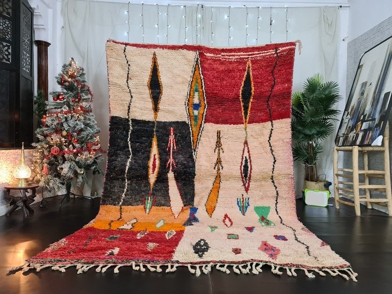 Handmade Moroccan Berber Wool Area Rug 9.84 x 6.56 Feet: Handmade Moroccan Berber Wool Area Rug 9.84 x 6.56 Feet This stunning handmade Moroccan Berber wool area rug showcases a beautiful assortment of designs and shapes in vibrant colors. Crafted by local 