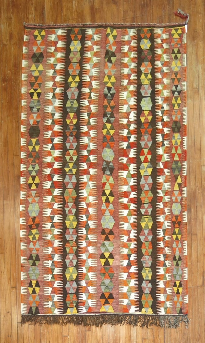 5' 7" x 9' 6" Mid 20th Century Turkish Kilim Rug: 5' 7" x 9' 6" Mid 20th Century Turkish Kilim Rug Vintage Turkish kilim from the mid-20th century featuring a tribal all-over pattern. Pre-owned condition. Specifications Type: Kilim Origin: Turkey Sty