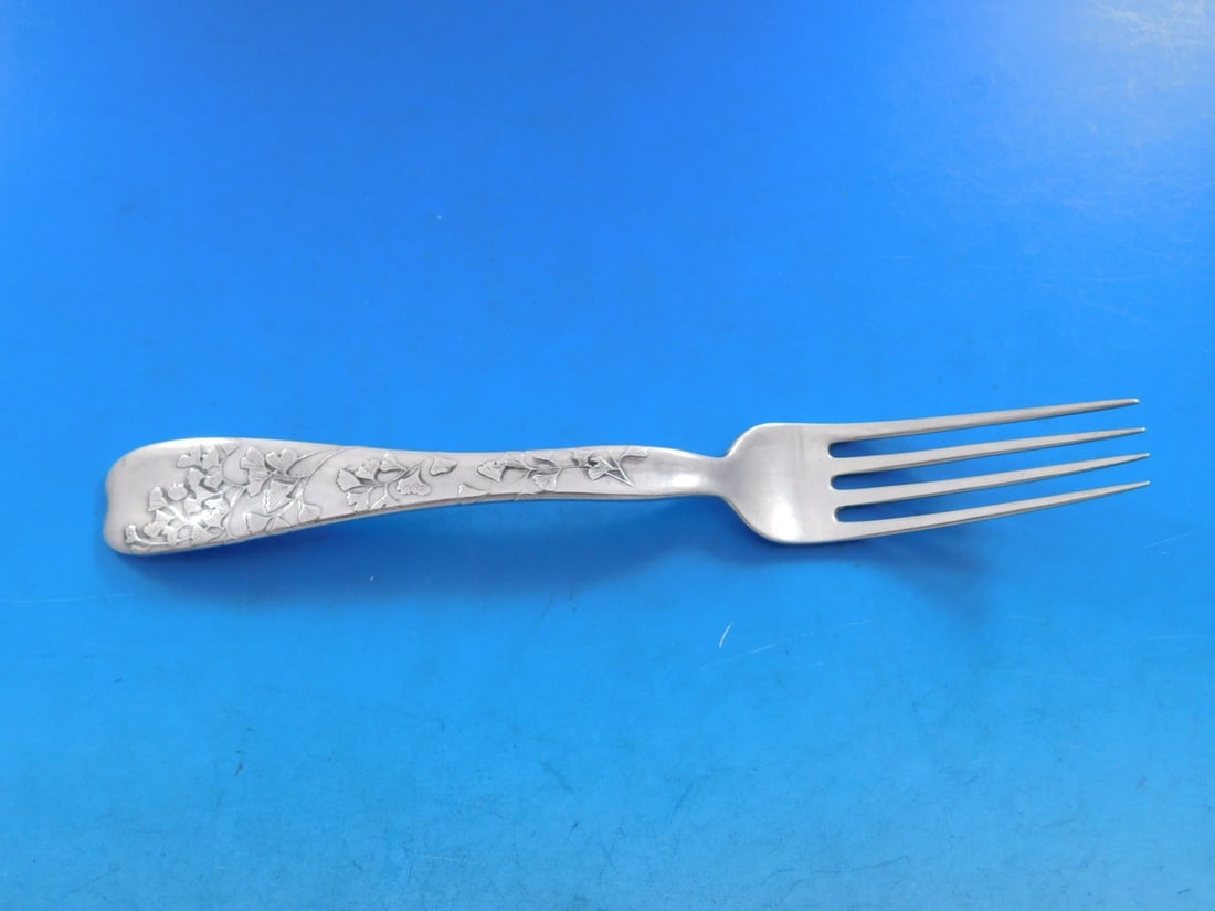 Tiffany & Co Sterling Silver Fork Lap Over Edge Gingko Leaf 7.25": Tiffany & Co Sterling Silver Fork Lap Over Edge Gingko Leaf 7.25" This exquisite sterling silver regular fork by Tiffany & Co. features the elegant Lap Over Edge pattern, beautifully enhanced with an 