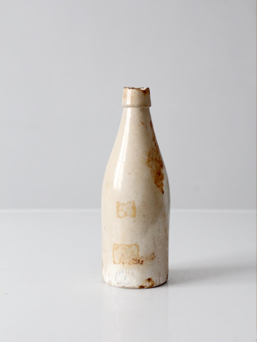 Midland Pottery Melling antique English stoneware bottle 8.5 inch: Midland Pottery Melling antique English stoneware bottle 8.5 inch Antique English stoneware bottle by Midland Pottery of Melling, featuring a slender tapered form, narrow neck, and a creamy off-white 