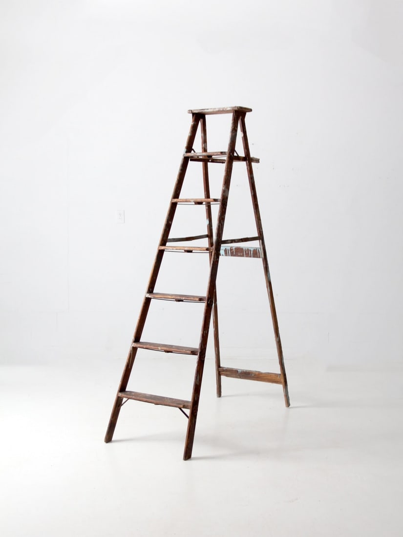 6.5Ft Wooden Painter Ladder with 6 Rungs: 6.5Ft Wooden Painter Ladder with 6 Rungs This vintage wooden painter's ladder stands out with its six rungs, folding metal hinges, and a weathered, timeworn finish that adds character to any space. Id