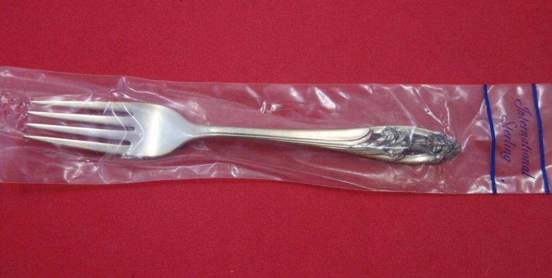 International Silver Iris Sterling Silver Fork 7 1/4 in: International Silver Iris Sterling Silver Fork 7 1/4 in Silver Iris by International sterling silver regular fork in the original factory sleeve. This pre-owned piece is not monogrammed and is describ
