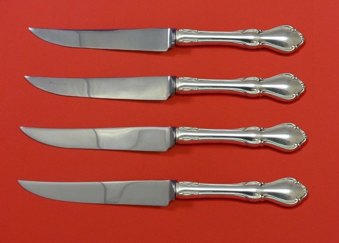 Reed & Barton Hampton Court Sterling Silver Steak Knife Set 4pc: Reed & Barton Hampton Court Sterling Silver Steak Knife Set 4pc This exquisite 4-piece steak knife set features the Hampton Court pattern by Reed & Barton, crafted from high-quality sterling silver. E