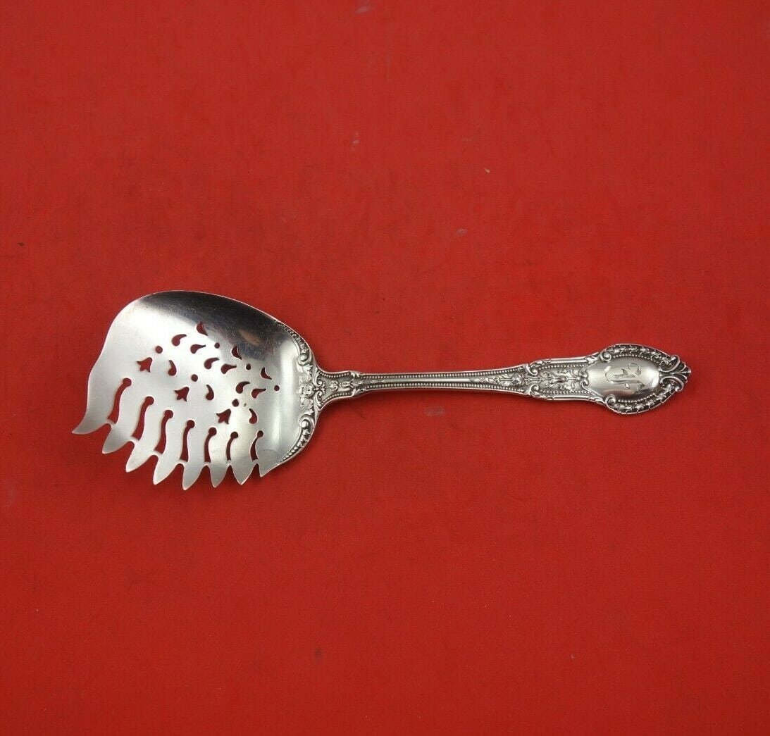 Gorham Tuileries sterling silver cucumber server 6 1/8 in: Gorham Tuileries sterling silver cucumber server 6 1/8 in Sterling silver cucumber server in the Tuileries pattern by Gorham. This serving piece features teeth and a decorative design, and it is monog