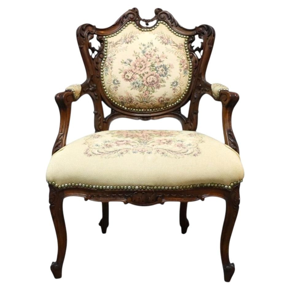 c1900 Louis XV Style Mahogany Fauteuil with Floral Tapestry Upholstery: c1900 Louis XV Style Mahogany Fauteuil with Floral Tapestry Upholstery Antique Louis XV style fauteuil chair crafted from mahogany with intricate floral carving and a curvilinear frame. The seat and b