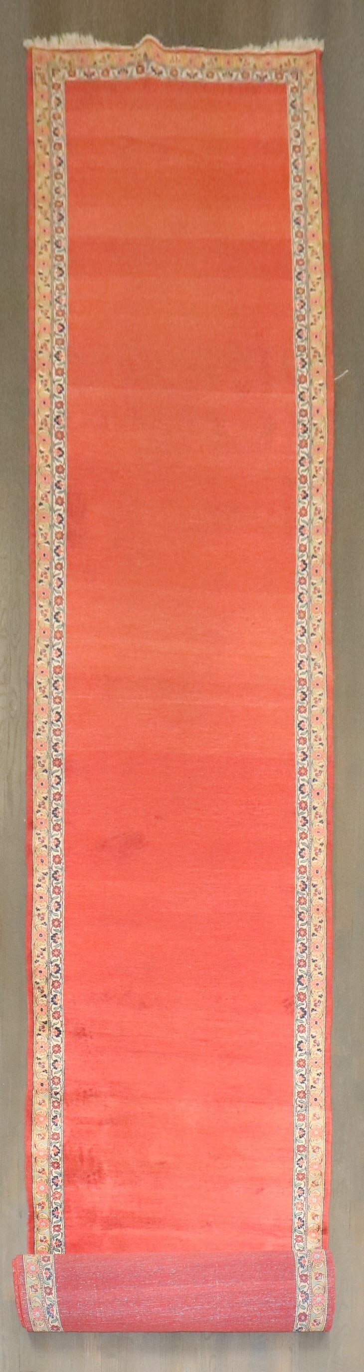 3' 6" x 28' 6" Persian Kashan runner with open red field: 3' 6" x 28' 6" Persian Kashan runner with open red field Early 20th century Persian Kashan runner featuring an open red field pattern framed by two thin floral borders. This pre-owned runner is identi