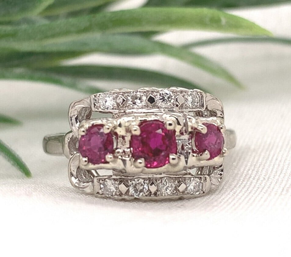 1940s Unbranded 14k White Gold Ruby Diamond Band Ring Size 6: 1940s Unbranded 14k White Gold Ruby Diamond Band Ring Size 6 Vintage 14k white gold band ring featuring three genuine natural round pinkish-red rubies and eight round diamond accents. The ring is set 