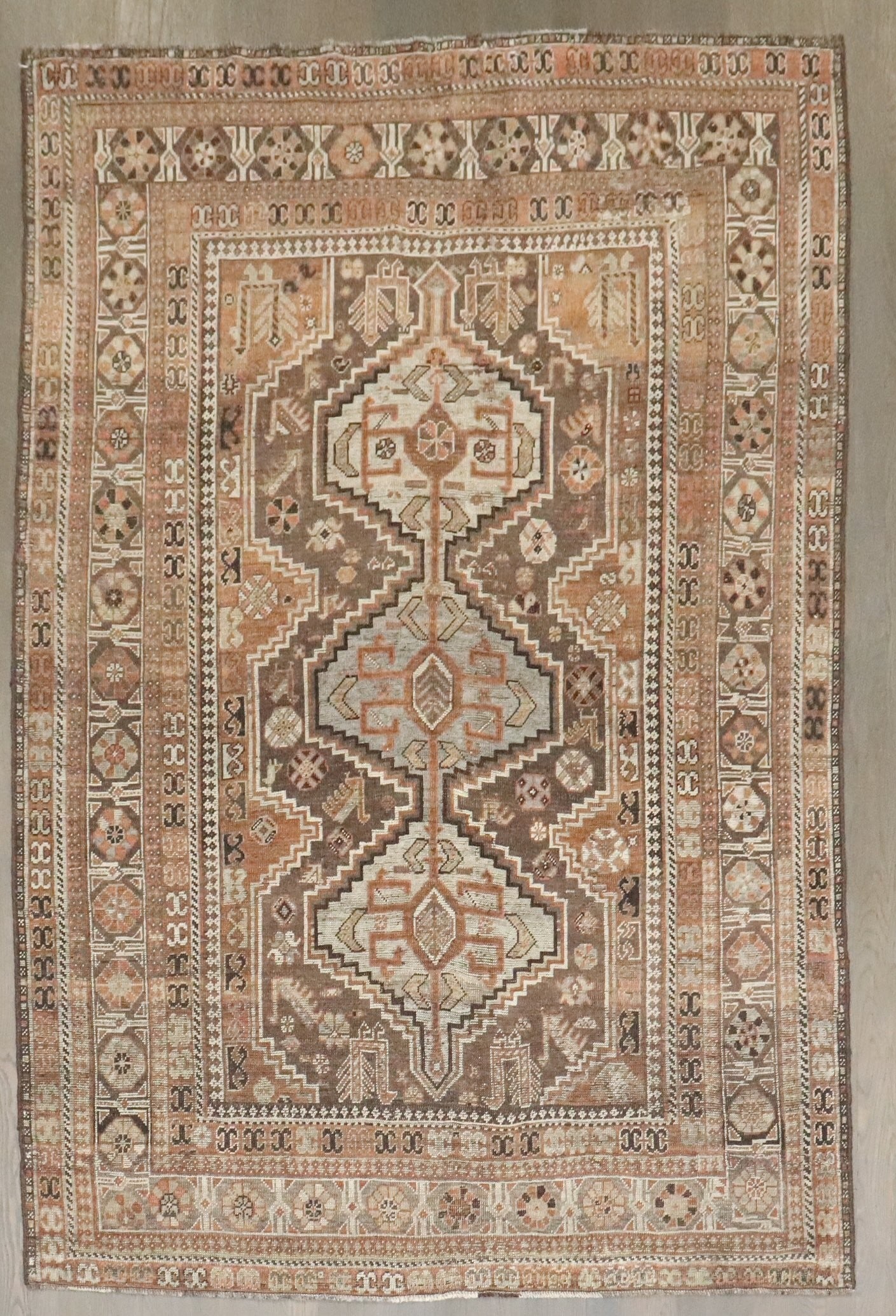 5' 4" x 7' 7" Brown Shiraz Persian Rug 1920s: 5' 4" x 7' 7" Brown Shiraz Persian Rug 1920s Antique Persian Shiraz geometric rug from the 1920s with a predominantly brown palette. This pre-owned piece features the classic geometric design associat