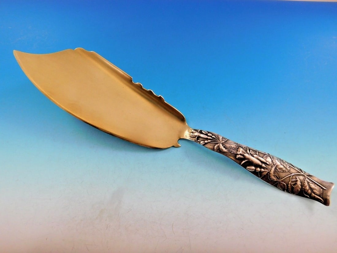 Shiebler Flora Sterling Silver Fish Server 13 Gold-Washed Floral Motif: Shiebler Flora Sterling Silver Fish Server 13 Gold-Washed Floral Motif This captivating fish server from the Flora pattern by Shiebler is crafted from sterling silver and measures 13 inches in length.