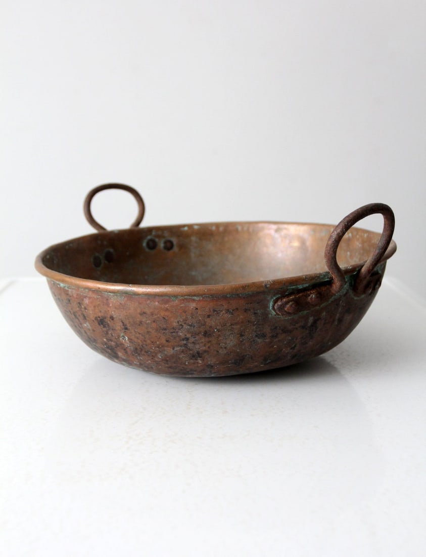 Antique Copper Preserving Pan with Iron Handles: Antique Copper Preserving Pan with Iron Handles This antique copper preserving pan features a unique shape, originally designed for preserving jams and jellies. The iron handles enhance its rustic cha