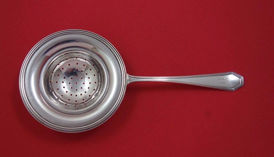 Dominick & Haff Queen Anne Plain Sterling Silver Tea Strainer 7 1/4": Dominick & Haff Queen Anne Plain Sterling Silver Tea Strainer 7 1/4" This exquisite tea strainer features the elegant Queen Anne Plain pattern by Dominick & Haff. Crafted from high-quality sterling si