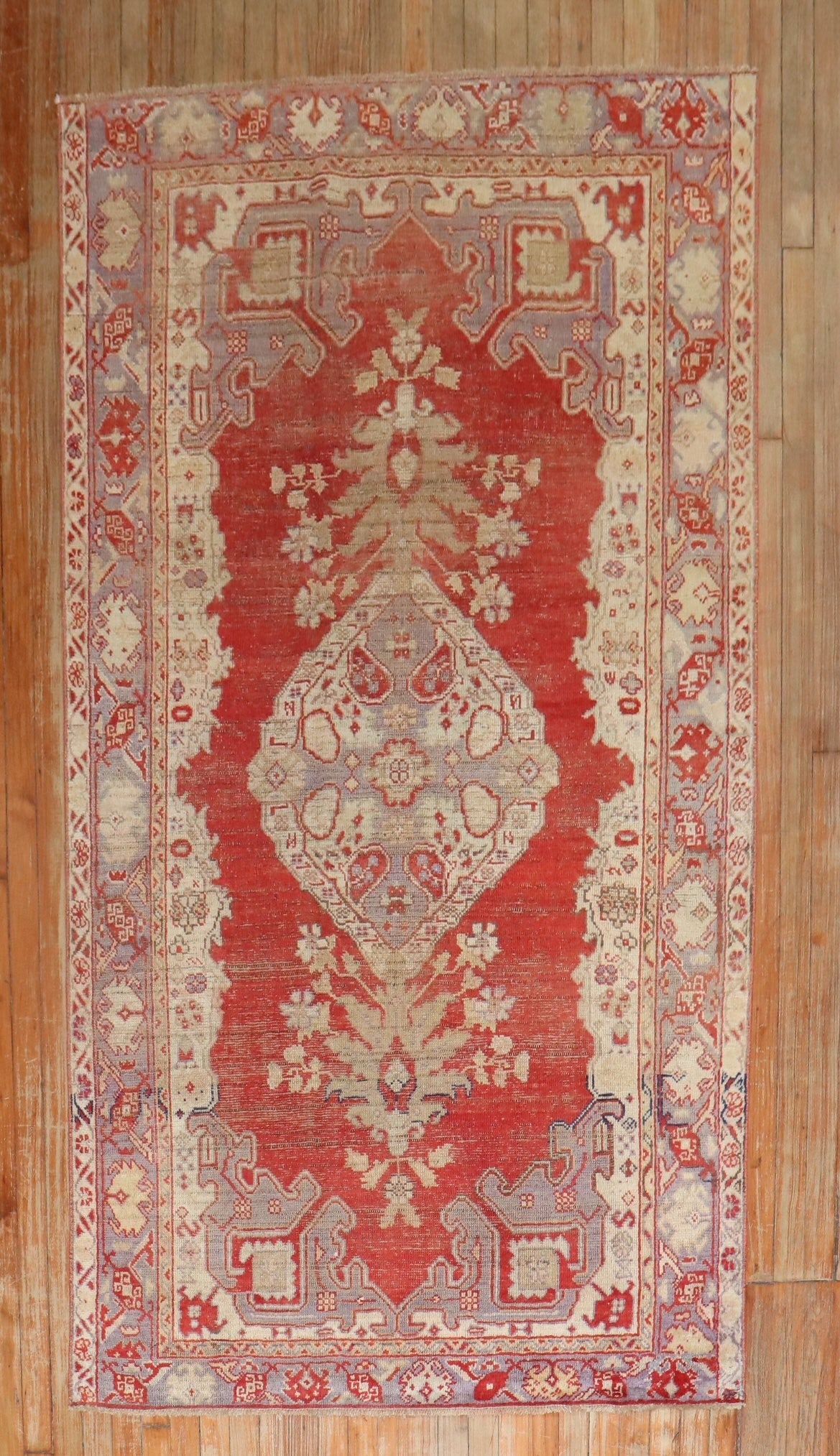 4' 3" x 7' 4" 1930s Turkish Kula Accent Rug: 4' 3" x 7' 4" 1930s Turkish Kula Accent Rug Vintage Turkish Kula accent rug from the 1930s with a worn finish and a red field. The design features intricate floral and geometric motifs, consistent wit