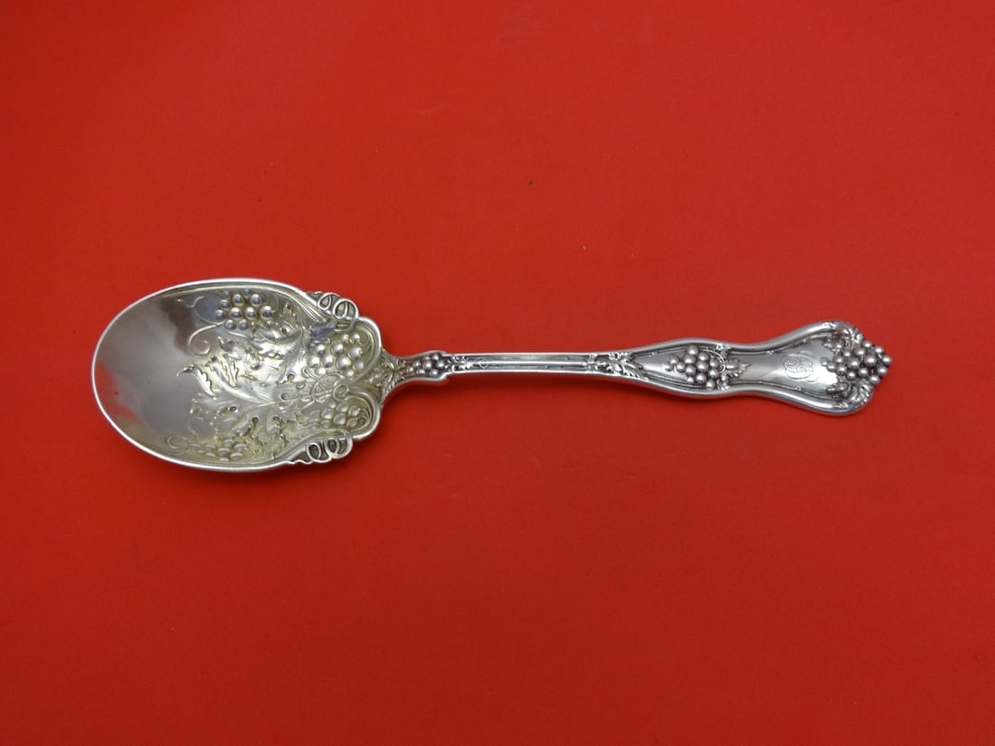 Dominick & Haff Grape Sterling Silver Preserve Spoon Gold Wash 7.25": Dominick & Haff Grape Sterling Silver Preserve Spoon Gold Wash 7.25" Discover the elegance of the Grape pattern serving spoon by Dominick & Haff. This exquisite preserve spoon is crafted from high-qua