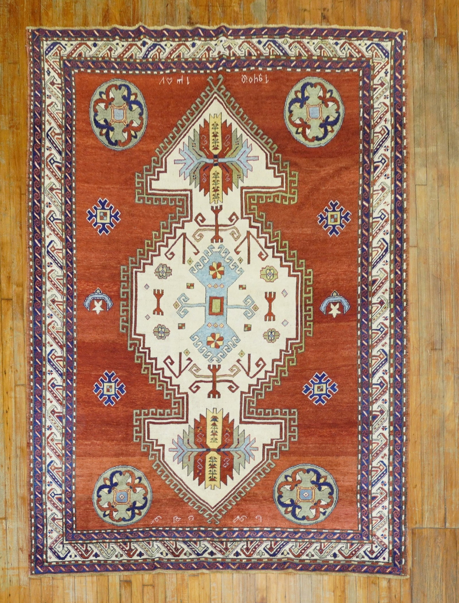 6' 5" x 9' 1" Armenian Kazak Rug dated 1940: 6' 5" x 9' 1" Armenian Kazak Rug dated 1940 Antique Armenian rug dated 1940 with a design resembling an antique Caucasian Lori Pambak Kazak rug. It features an angular ivory medallion set on a cherry 