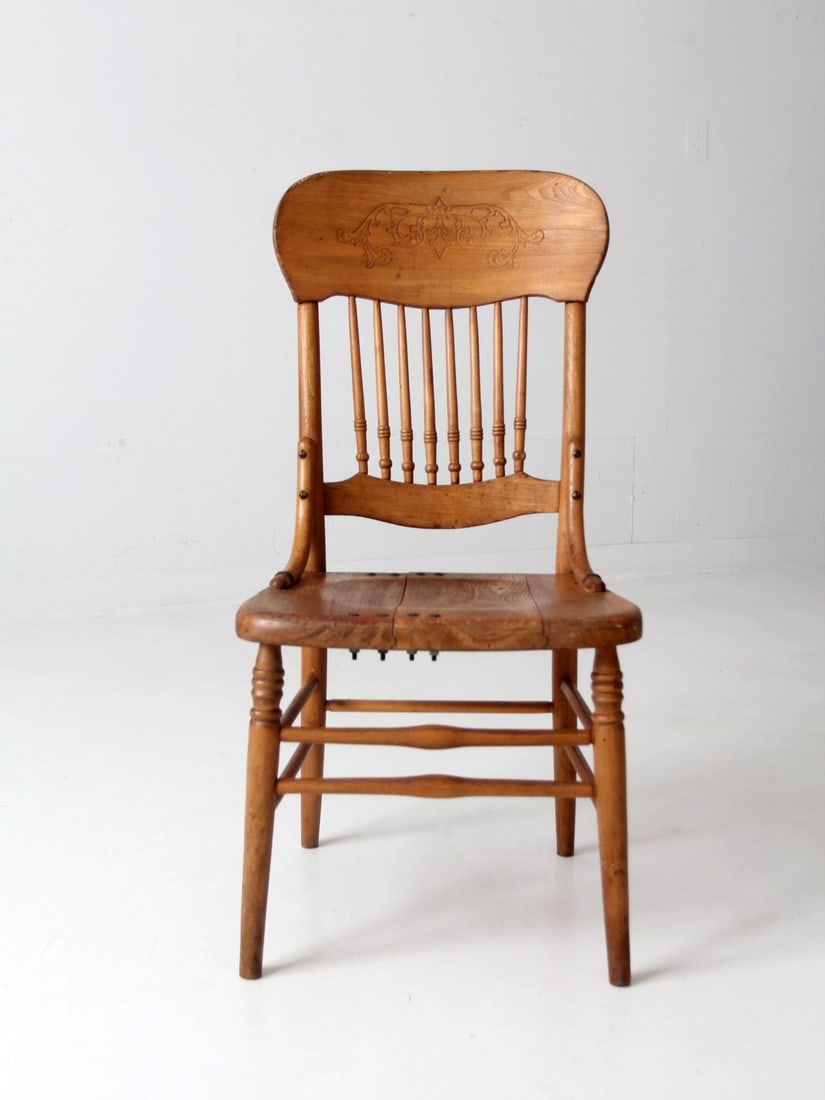 19th Century Antique Carved Spindle Back Dining Chair: 19th Century Antique Carved Spindle Back Dining Chair This exquisite 19th-century antique dining chair features a striking spindle back and a beautifully carved top rail. The wood showcases a lovely p