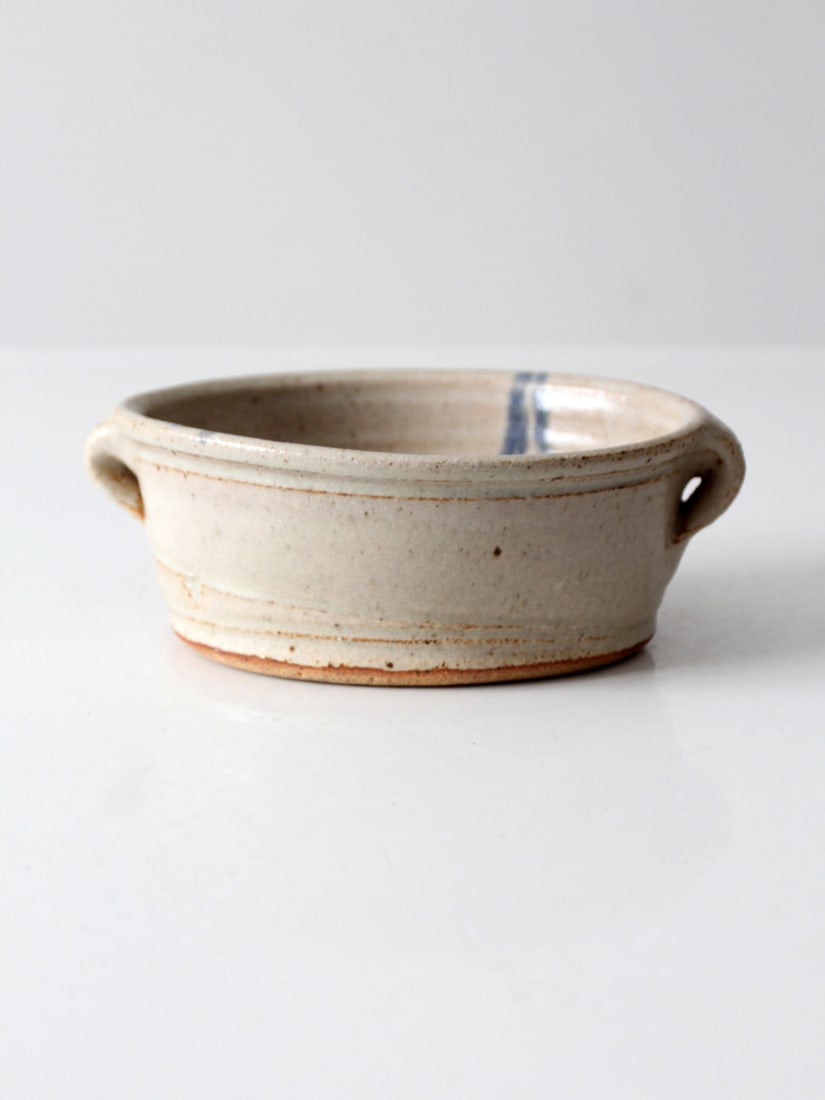 Gray Stoneware Oval Pottery Bowl with Blue Brushstroke Handles: Gray Stoneware Oval Pottery Bowl with Blue Brushstroke Handles Discover the beauty of this vintage handmade studio pottery bowl, showcasing a soft gray stoneware glaze complemented by a hand-painted b