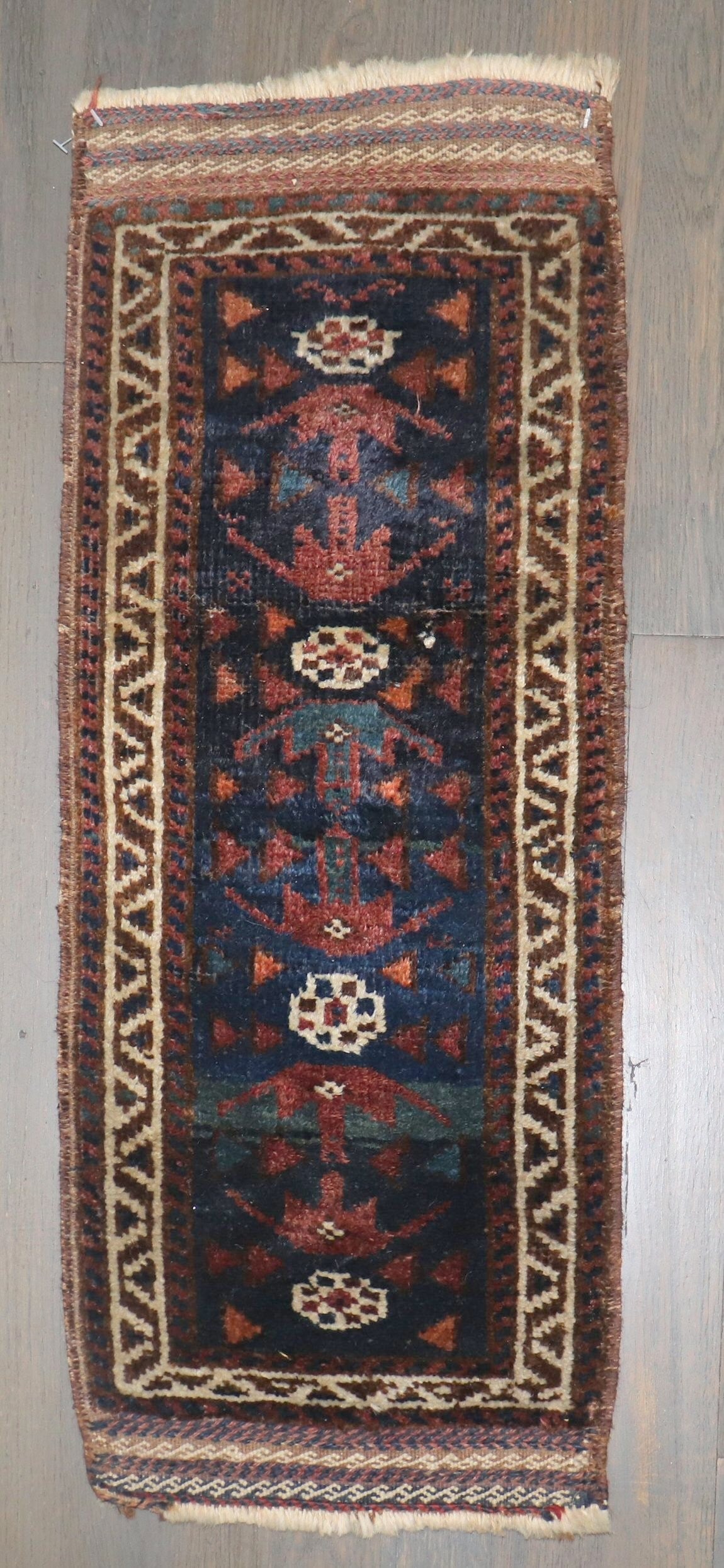 11" x 2' 4" Early 20th Century Balouch Yastik Rug: 11" x 2' 4" Early 20th Century Balouch Yastik Rug Early 20th century tribal Balouch mini size rug in the yastik category. This pre-owned piece offers a compact format with traditional Balouch characte