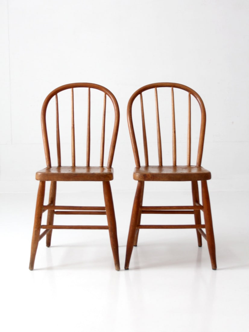 Vintage Windsor Bow Back Chair Pair Honey Finish: Vintage Windsor Bow Back Chair Pair Honey Finish This pair of vintage Windsor bow back chairs features a warm honey-toned finish and a gracefully curved silhouette highlighted by slender spindles and 