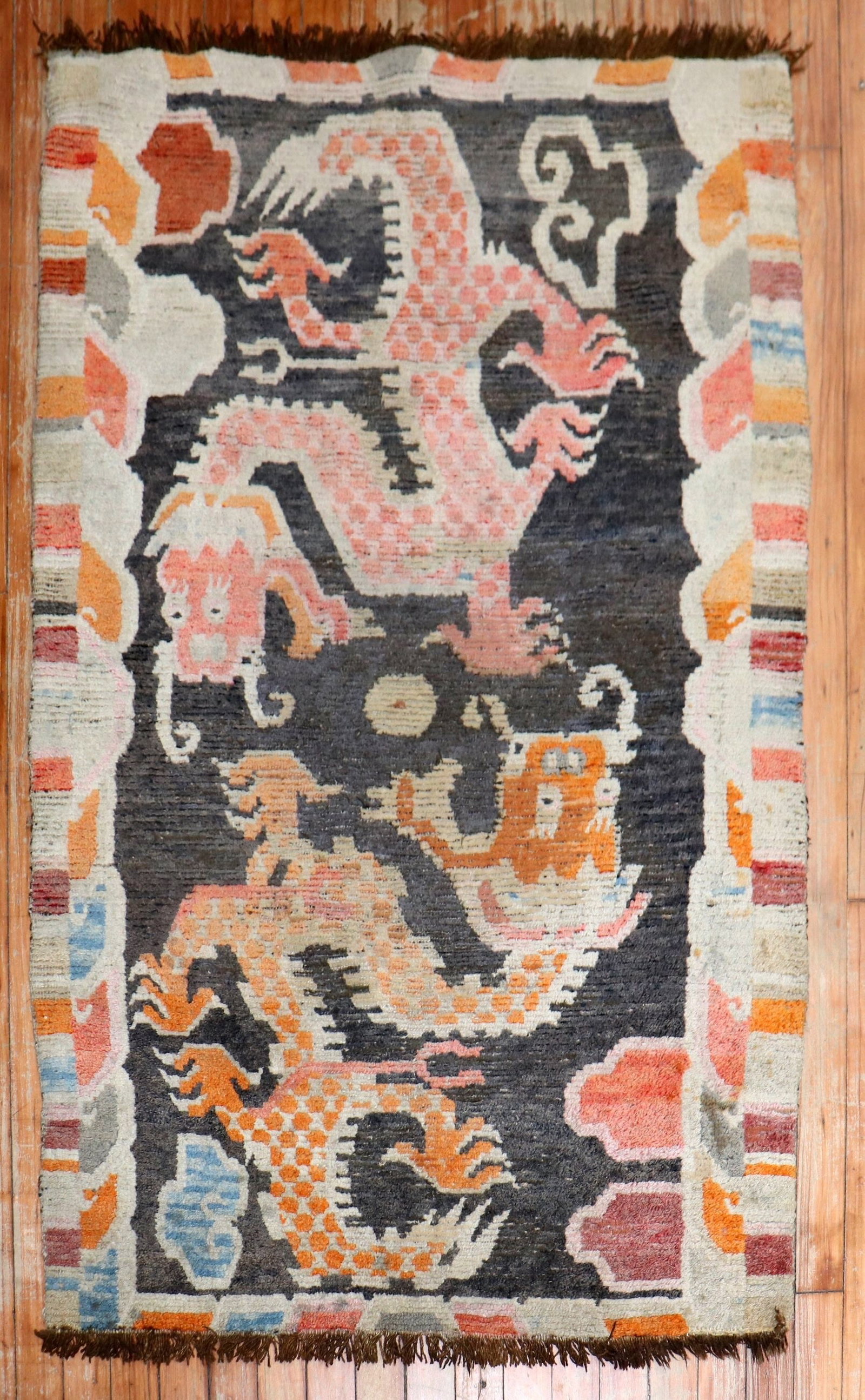 3' x 4' 7" Early 20th Century Tibetan Double Dragon Rug: 3' x 4' 7" Early 20th Century Tibetan Double Dragon Rug Early 20th century Tibetan pictorial rug featuring a double dragon design. This pre-owned small rug reflects vintage Tibetan craftsmanship and d