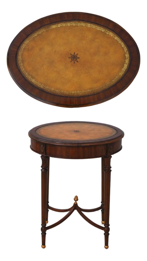 Maitland Smith Regency Mahogany Side Table with Oval Leather Top: Maitland Smith Regency Mahogany Side Table with Oval Leather Top Oval Regency-style end table with a tooled leather top and mahogany frame. This pre-owned piece features brass-capped feet, a stretcher