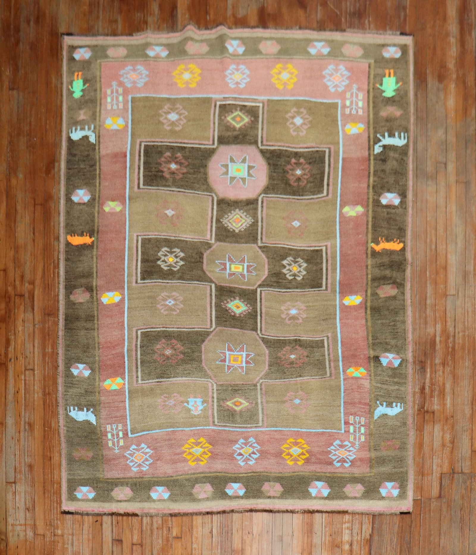6' 8" x 9' 2" Turkish Kars Pictorial Rug with Human and Animal Border: 6' 8" x 9' 2" Turkish Kars Pictorial Rug with Human and Animal Border Mid-century Turkish Kars pictorial rug with a brown field and a colorful border featuring two human figures and animals. This pre-