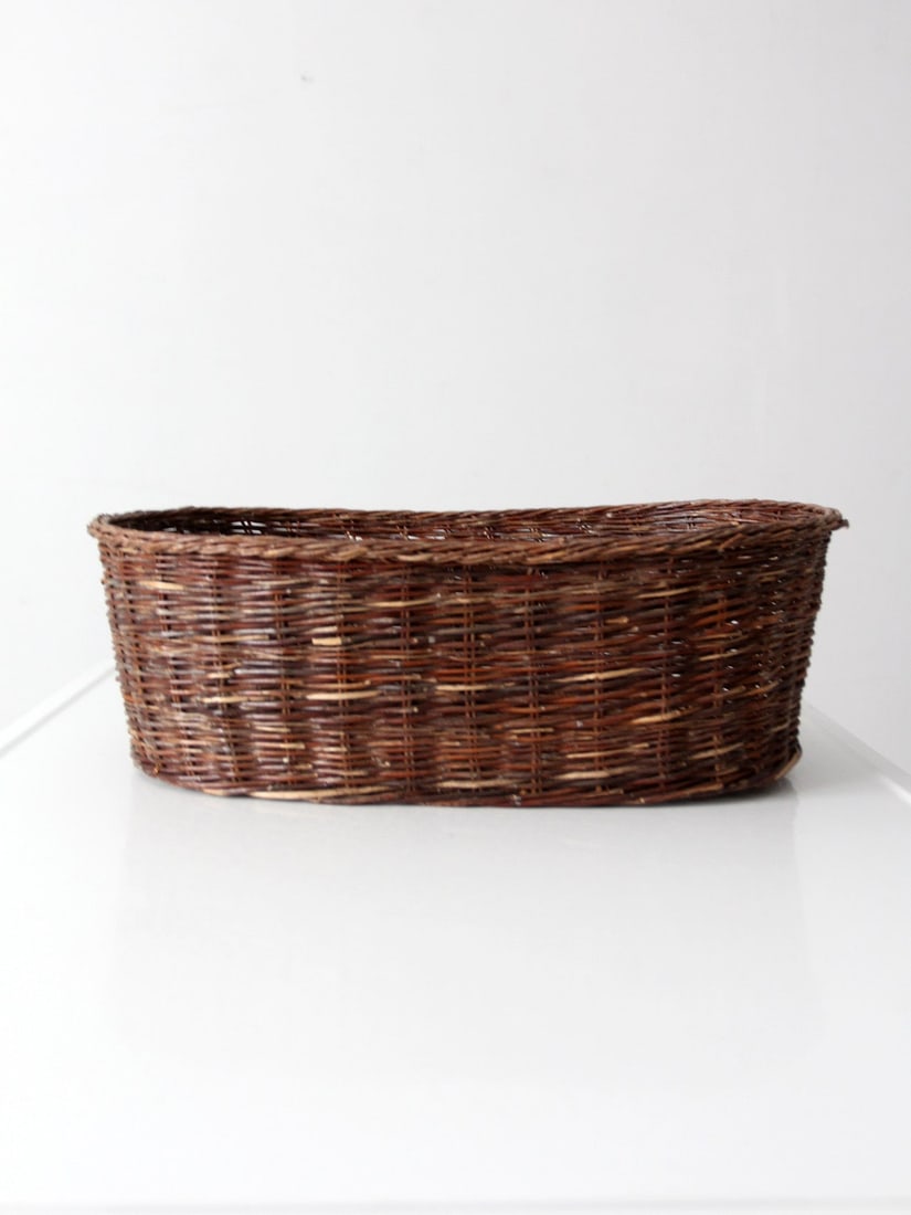 Handwoven Willow Oval Basket 19 inch Vintage Storage Tray: Handwoven Willow Oval Basket 19 inch Vintage Storage Tray This vintage oval wicker basket is handwoven from natural willow and features an elongated oval shape with a low profile. Its rich brown tones