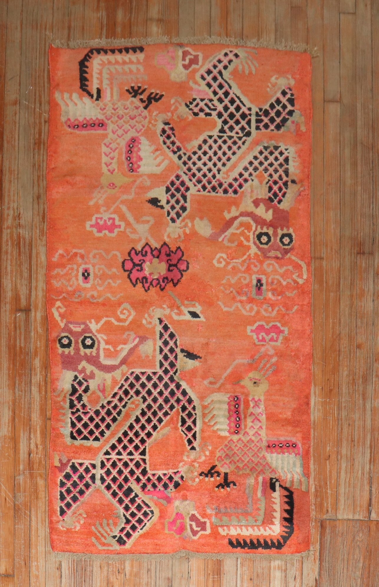 3' 1" x 5' 9" Mid 20th Century Tibetan Pictorial Dragon Rug: 3' 1" x 5' 9" Mid 20th Century Tibetan Pictorial Dragon Rug Mid-20th century Tibetan pictorial rug featuring a dragon motif in an orange colorway. This small pre-owned rug offers a distinctive decorat
