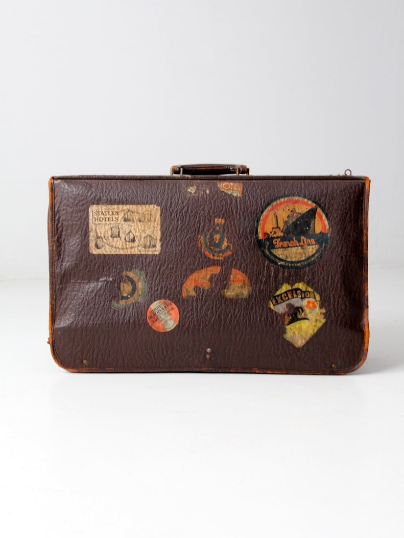 1940s K Kaufmann Tour-Aider Vintage Suitcase with Travel Stickers: 1940s K Kaufmann Tour-Aider Vintage Suitcase with Travel Stickers This 1940s Tour-Aider suitcase by K. Kaufmann & Co. features a rich brown leatherette surface adorned with travel stickers from French