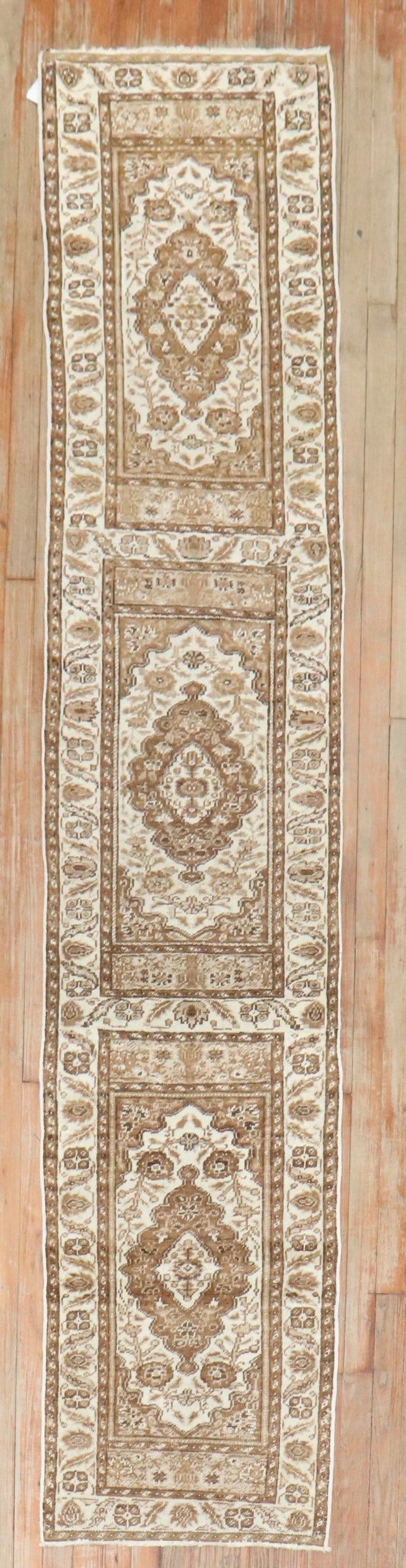 1' 11" x 9' 1" Mid 20th Century Turkish Runner Rug: 1' 11" x 9' 1" Mid 20th Century Turkish Runner Rug A vintage Turkish runner in a neutral color palette, featuring a narrow profile suited to hallways or long spaces. This mid-20th century piece is off