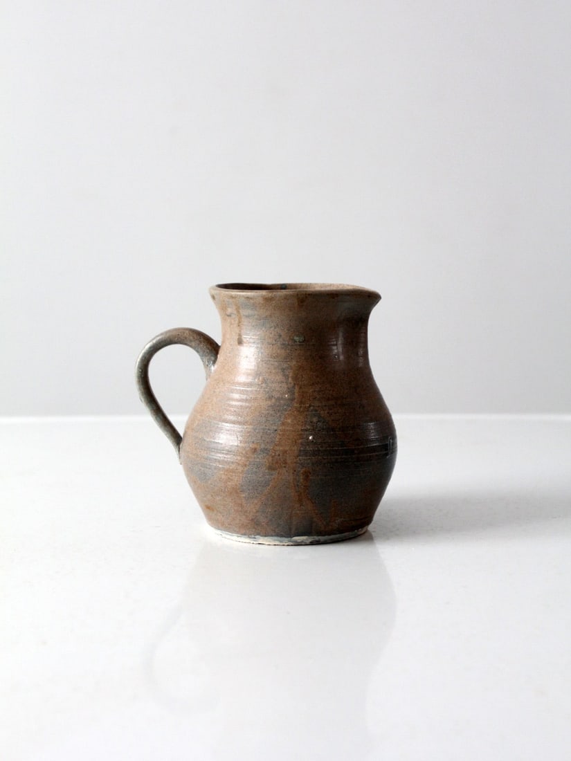 Handcrafted Vintage Studio Pottery Pitcher Taupe Blue Glaze 6 Inches Tall: Handcrafted Vintage Studio Pottery Pitcher Taupe Blue Glaze 6 Inches Tall This vintage hand-crafted studio pottery pitcher showcases a stunning taupe and blue glaze, making it a unique addition to any