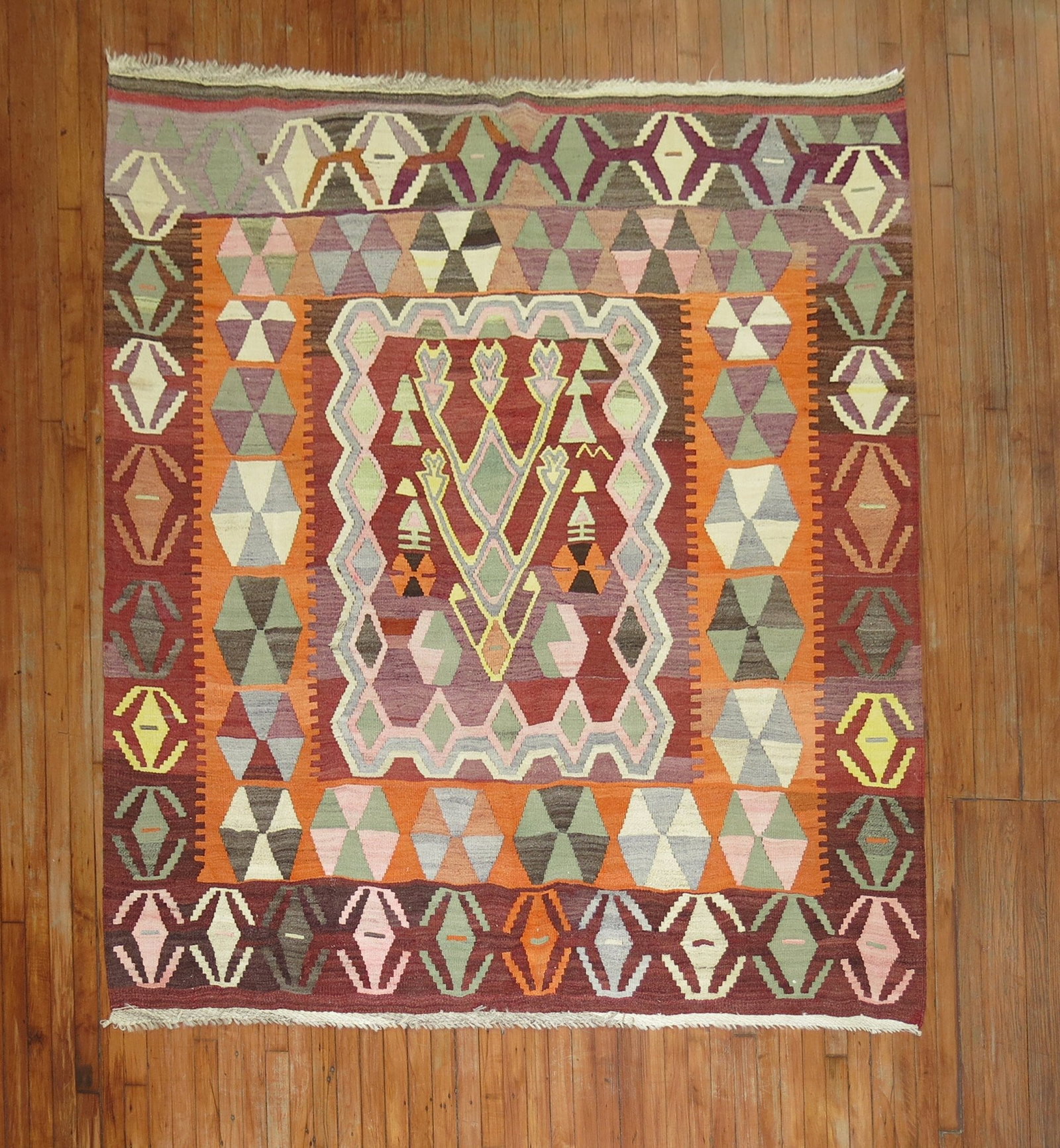 6' 8" x 7' Mid 20th Century Turkish Square Kilim Rug: 6' 8" x 7' Mid 20th Century Turkish Square Kilim Rug Vintage Turkish square kilim from the mid 20th century. This pre-owned rug features a colorful geometric design with floral motifs, consistent with