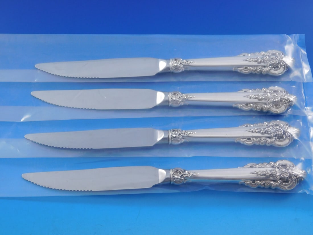 Wallace Grande Baroque Sterling Silver Steak Knife Set 4pc 9 1/4": Wallace Grande Baroque Sterling Silver Steak Knife Set 4pc 9 1/4" Enhance your dining experience with this exquisite 4-piece steak knife set from the renowned Grande Baroque pattern by Wallace. Crafte