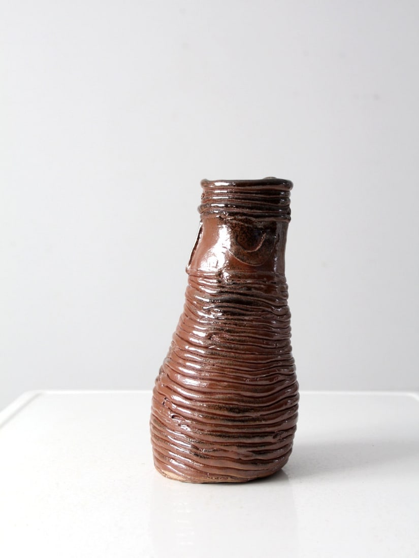 Handcrafted Vintage Coiled Pottery Vase with Russet Glaze: Handcrafted Vintage Coiled Pottery Vase with Russet Glaze This vintage studio pottery vase showcases a unique coiled design, featuring a rich russet brown glaze and distinctive 'handle' detailing at t