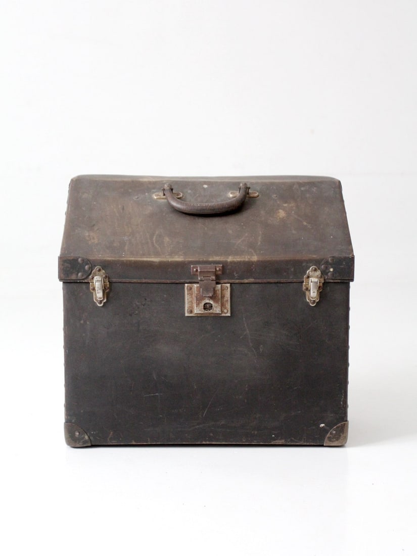 Slant Top Riveted Metal Travel Case with Leather Handle 17 inch: Slant Top Riveted Metal Travel Case with Leather Handle 17 inch Antique industrial travel case trunk with a distinctive slant-top form and riveted metal construction. This vintage piece dates to the 1
