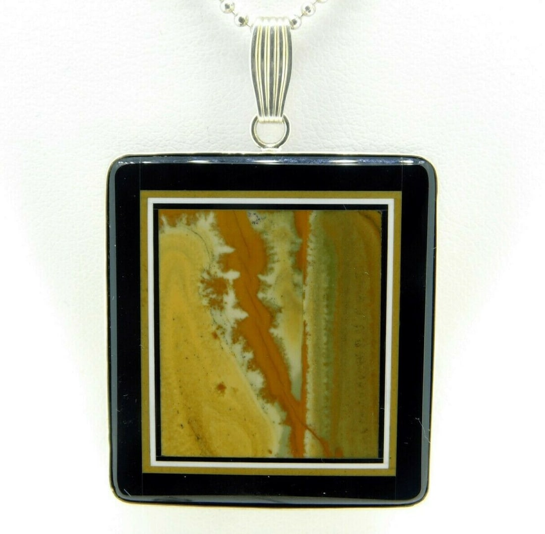 Jim Kaufmann Sterling Intarsia Pendant with Agate and Onyx Necklace: Jim Kaufmann Sterling Intarsia Pendant with Agate and Onyx Necklace This stunning pendant features exquisite intarsia craftsmanship by Jim Kaufmann, showcasing a beautiful inlay of genuine natural aga